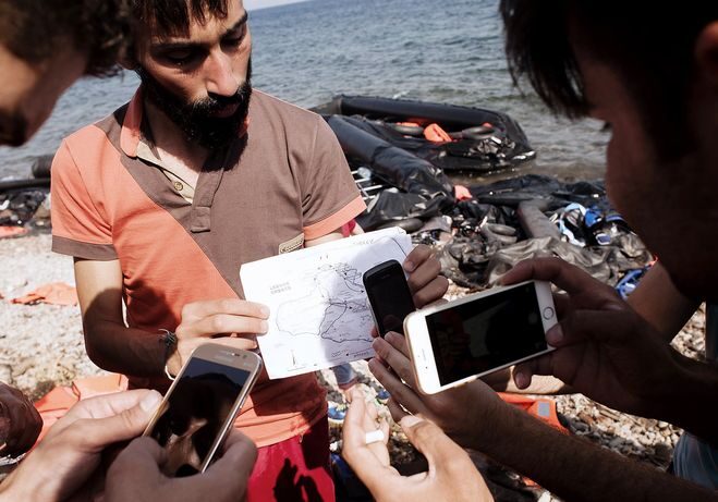 Refugees with smartphones.